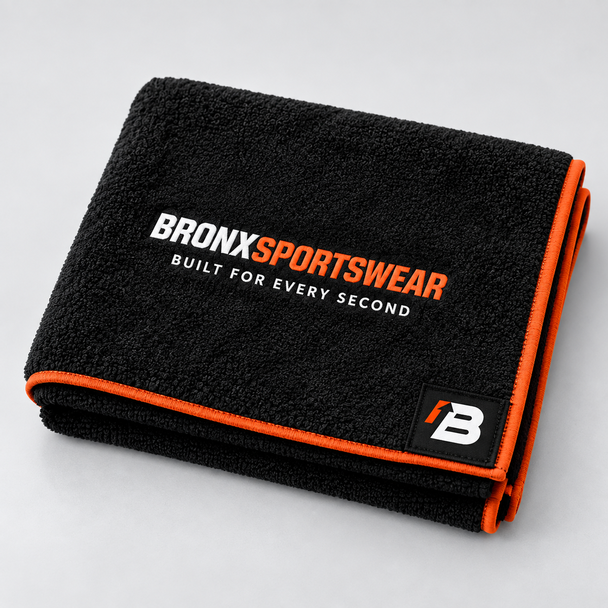 BronxSportswear black gym towel with orange trim, signature logo and Built for Every Second branding